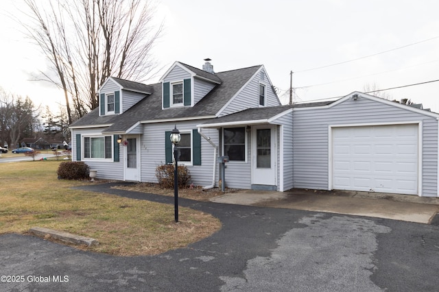 cape cod-style house featuring a front yard and a garage