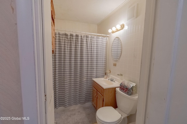 bathroom featuring curtained shower, tile walls, toilet, vanity, and crown molding