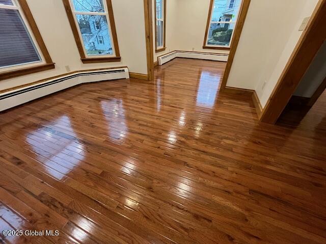 details with hardwood / wood-style floors and baseboard heating