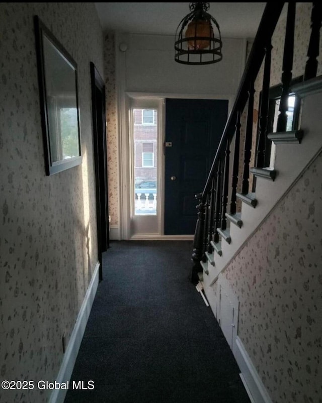 carpeted foyer featuring a wealth of natural light