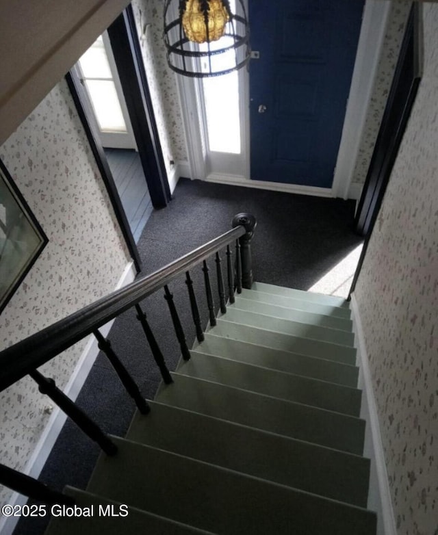 stairway featuring carpet and plenty of natural light