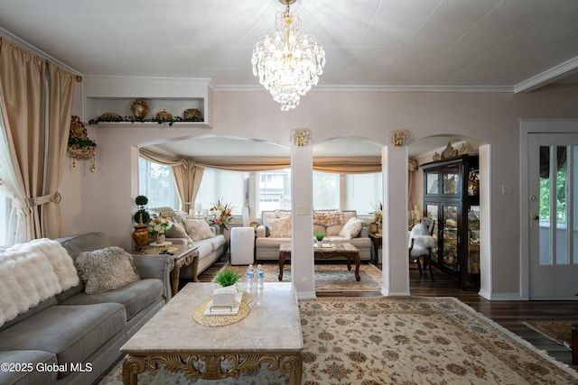 living room featuring a chandelier, wood-type flooring, and ornamental molding