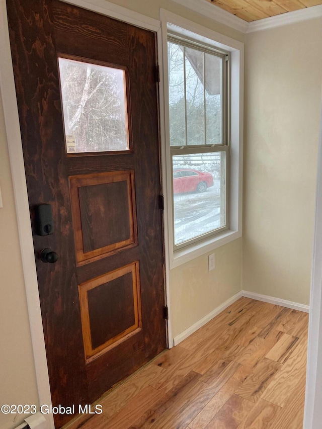 interior details with hardwood / wood-style flooring and crown molding