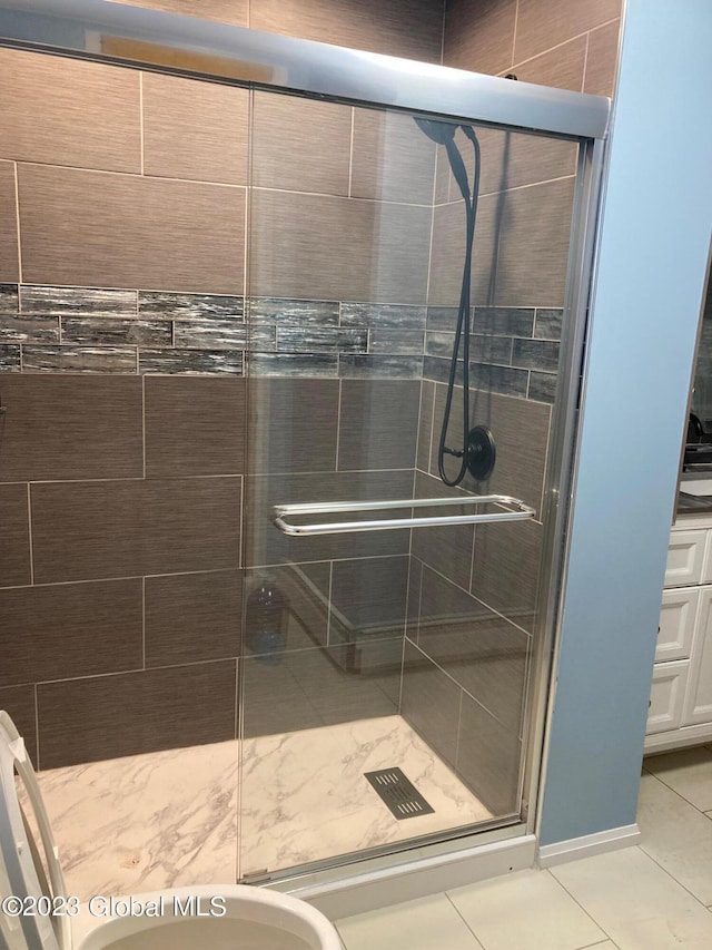 bathroom featuring tile patterned floors, walk in shower, and a bidet