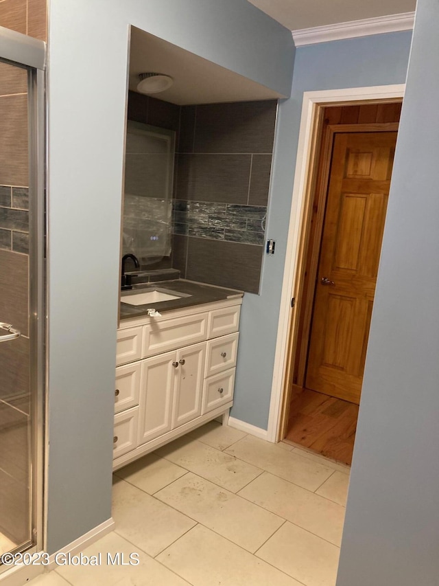 bathroom featuring ornamental molding, tile patterned flooring, and vanity