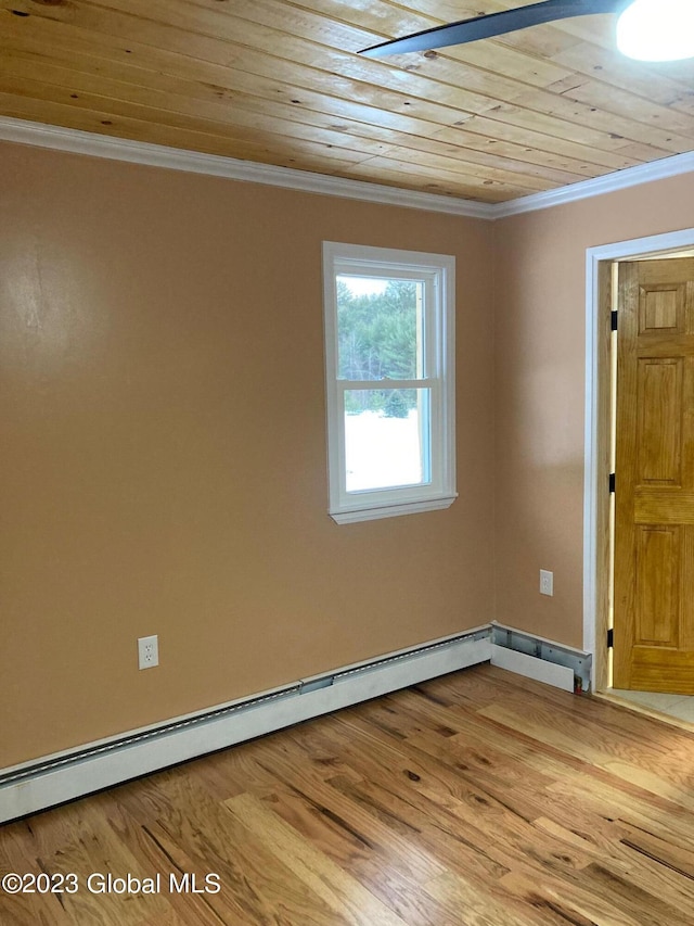 empty room featuring baseboard heating, ornamental molding, light hardwood / wood-style flooring, and wooden ceiling