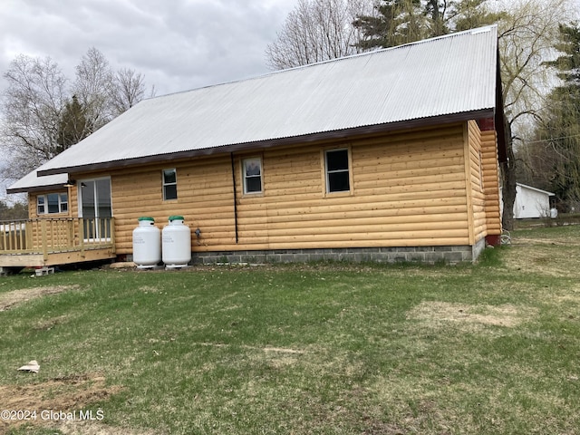 view of home's exterior with a deck and a yard