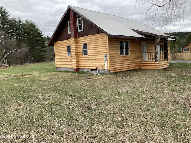 view of side of home featuring a lawn