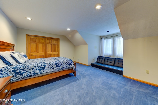 bedroom featuring vaulted ceiling, carpet floors, and a closet