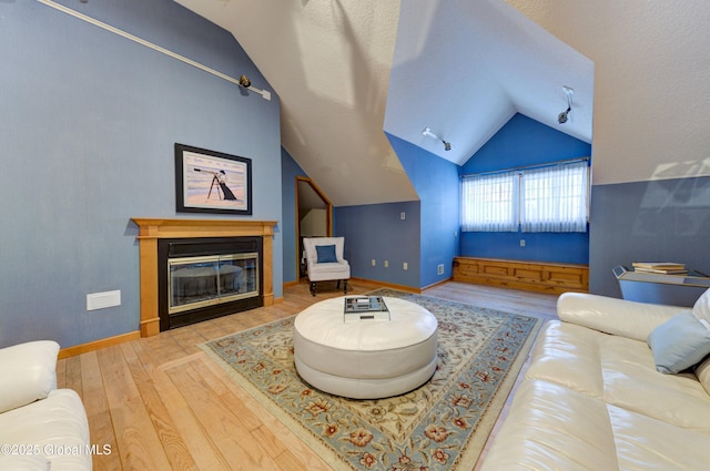 living room featuring hardwood / wood-style floors and vaulted ceiling