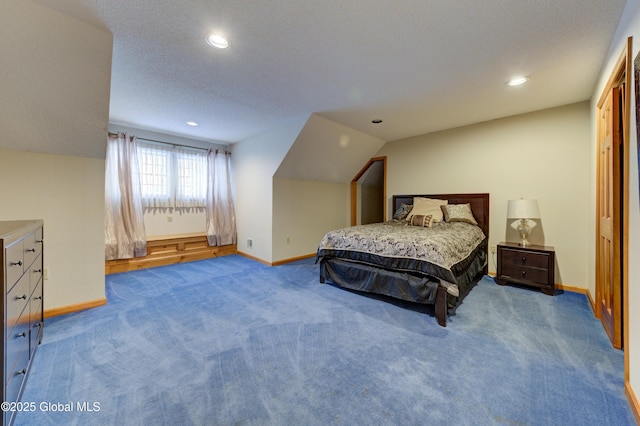 carpeted bedroom with vaulted ceiling