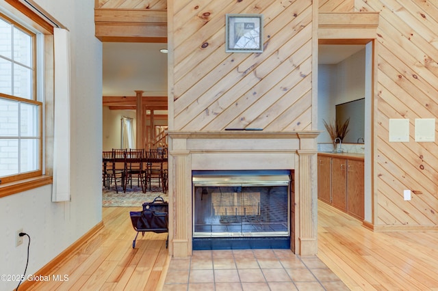 unfurnished living room featuring wood walls