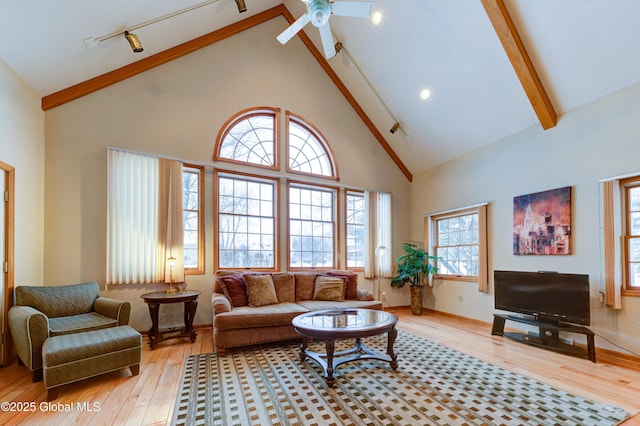 living room with high vaulted ceiling, ceiling fan, and light wood-type flooring