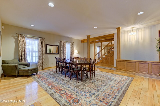 dining area with an inviting chandelier and hardwood / wood-style flooring