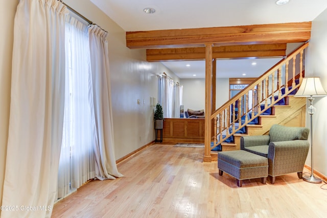 staircase featuring hardwood / wood-style floors and beam ceiling