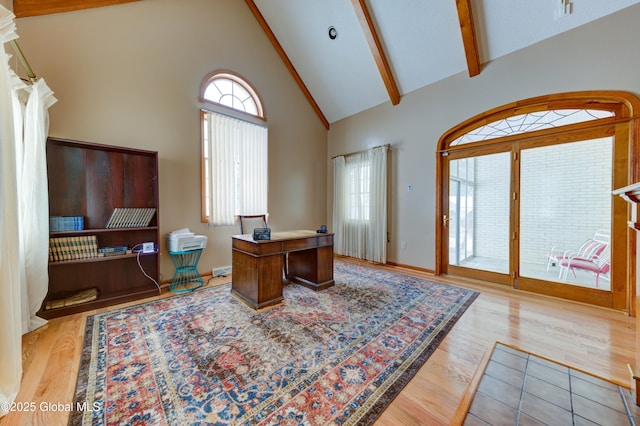 office featuring light hardwood / wood-style flooring, high vaulted ceiling, and beamed ceiling