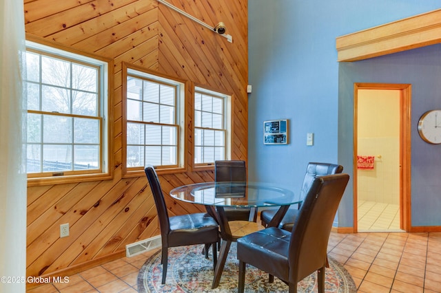 tiled dining area with wood walls