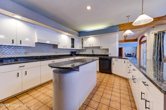 kitchen with black appliances, decorative backsplash, white cabinetry, wall chimney range hood, and decorative light fixtures