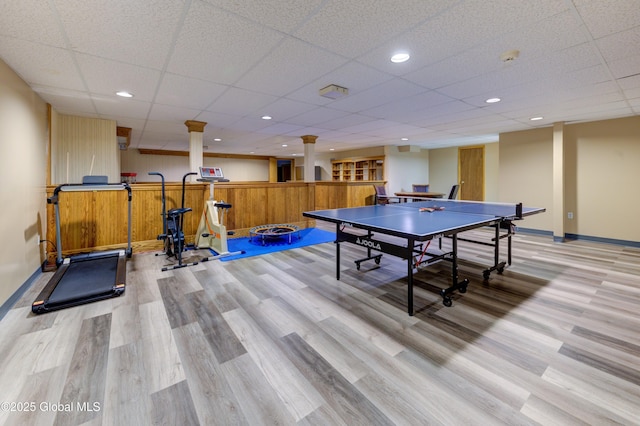 recreation room featuring a drop ceiling and light hardwood / wood-style flooring