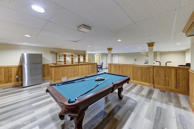 playroom with ornate columns, billiards, wood walls, and light hardwood / wood-style flooring