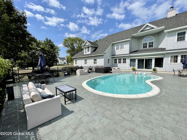 view of swimming pool with a hot tub and a patio