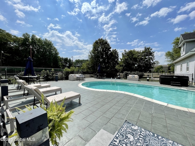 view of pool featuring a patio area and a hot tub