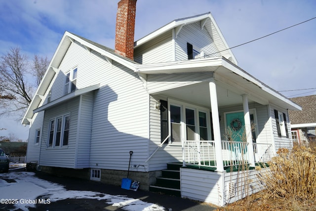 view of side of home featuring a porch