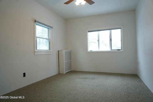 carpeted empty room featuring ceiling fan