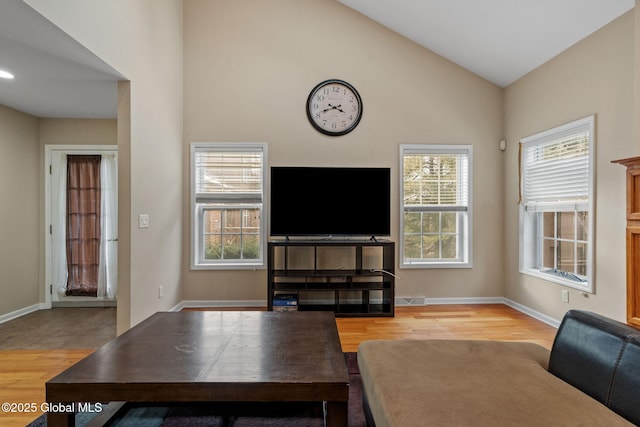 living room featuring vaulted ceiling and light hardwood / wood-style floors