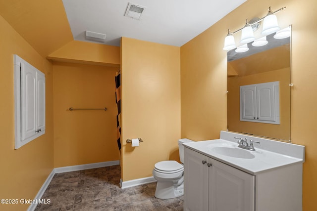 bathroom featuring toilet and vanity