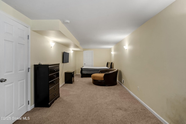 sitting room featuring light colored carpet