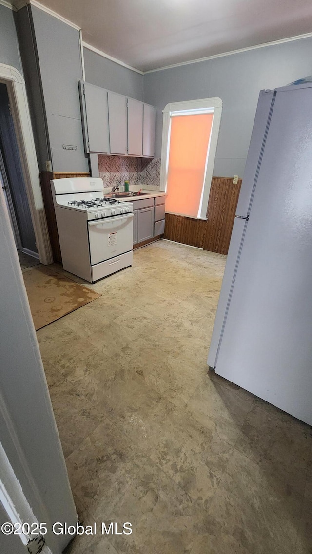 kitchen featuring white appliances and gray cabinets