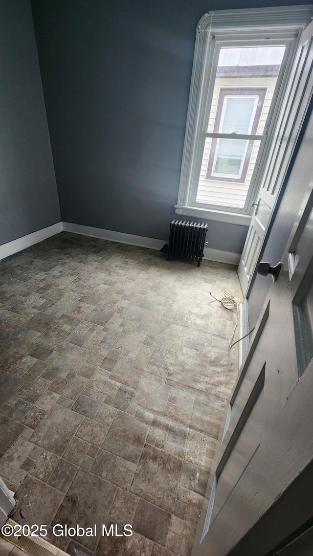 spare room featuring radiator