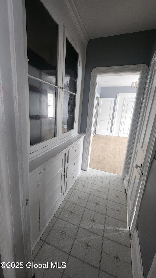 hallway featuring ornamental molding