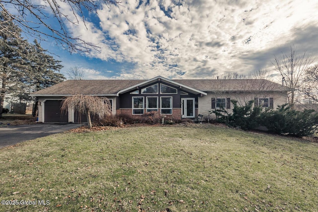 ranch-style home featuring a front yard and a garage