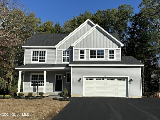 view of front of property featuring a garage and a porch