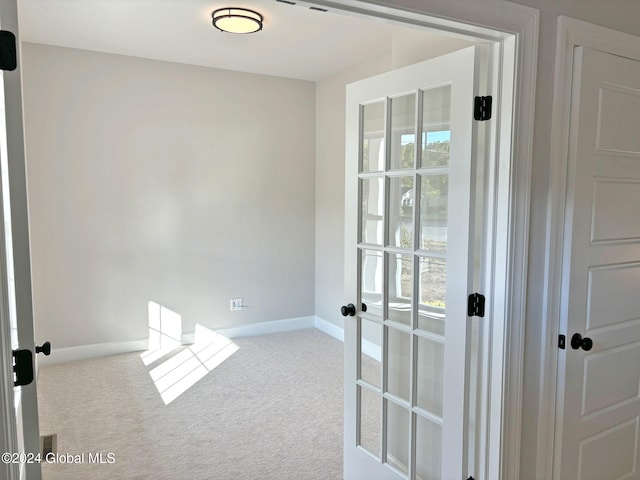 interior space with french doors and carpet