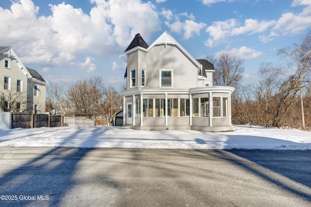 5 E Green St, Johnstown, NY 12095 - snow covered back of property with a sunroom and fence