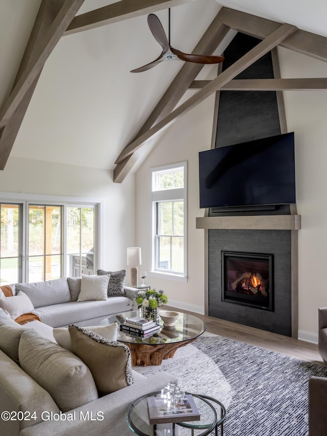 living room with ceiling fan, hardwood / wood-style floors, and lofted ceiling with beams