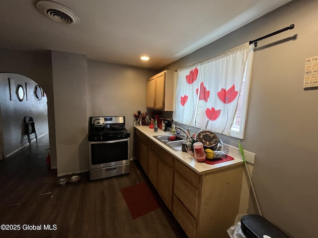 kitchen with dark wood-type flooring, stainless steel electric stove, and sink