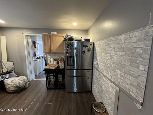 kitchen with tasteful backsplash, dark hardwood / wood-style floors, washer and dryer, light brown cabinetry, and stainless steel fridge