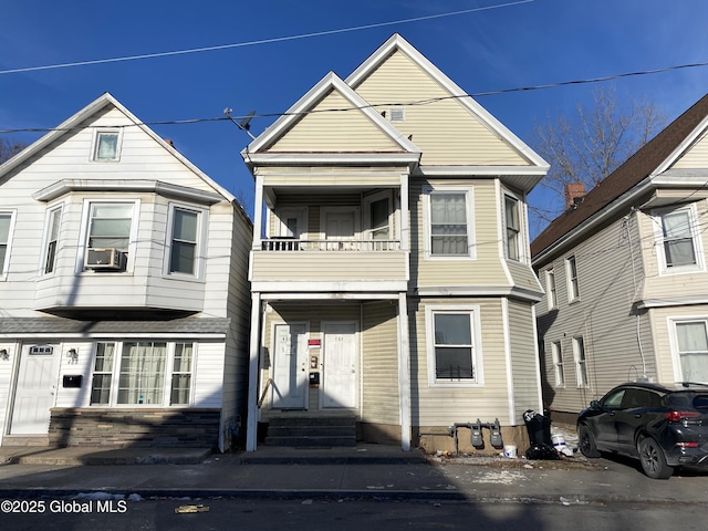 view of front of home featuring a balcony and cooling unit