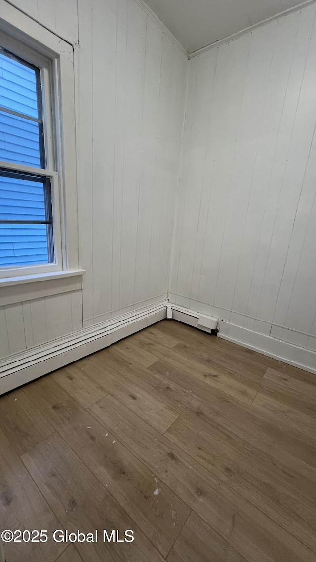 unfurnished room with hardwood / wood-style flooring