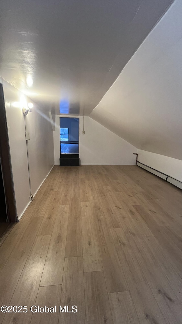 bonus room with light wood-type flooring