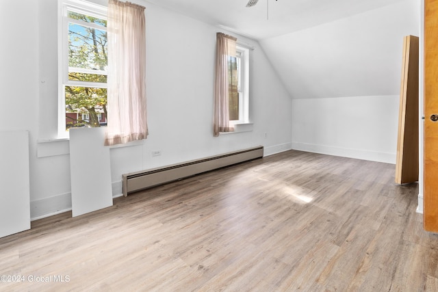 bonus room with a baseboard heating unit, ceiling fan, vaulted ceiling, and light hardwood / wood-style floors