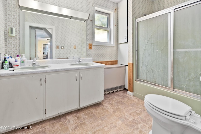 full bathroom featuring enclosed tub / shower combo, vanity, and toilet