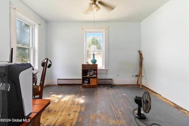 office space with a healthy amount of sunlight, ceiling fan, dark hardwood / wood-style flooring, and baseboard heating