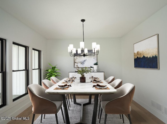 dining space with a notable chandelier and hardwood / wood-style floors