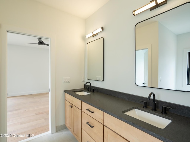 bathroom with ceiling fan and vanity