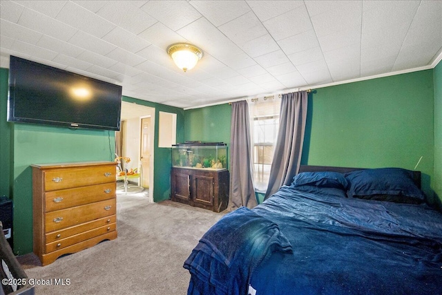 bedroom with crown molding and light colored carpet